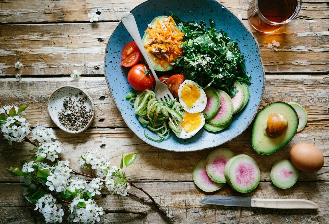 Healthy colorful salad bowl with avocado, boiled eggs, and fresh vegetables