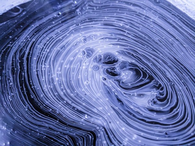 Abstract swirling blue liquid patterns
