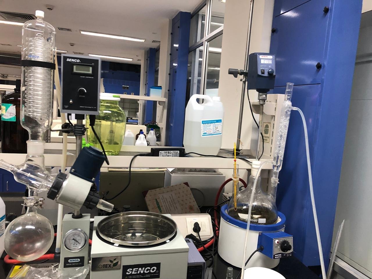 Various laboratory equipment including a rotary evaporator setup and a mechanical stirrer