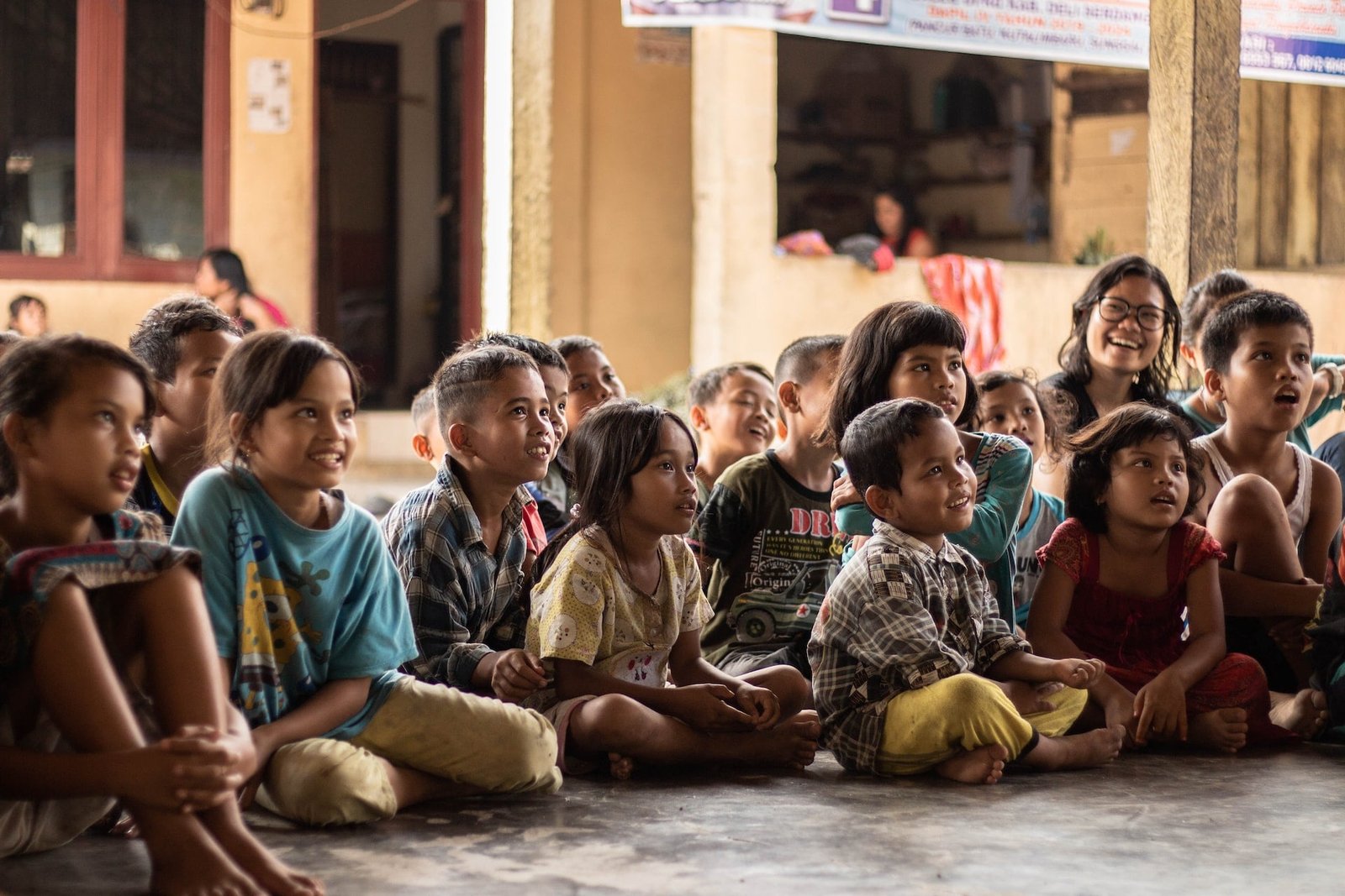 Group of diverse smiling children sitting on the floor